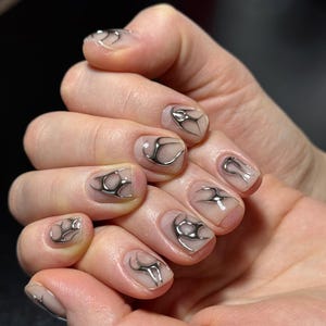 May include: A set of three ceramic mugs with a speckled, matte finish. The mugs are in shades of cream, light gray, and dark gray. Each mug has a simple, minimalist design, perfect for coffee or tea.