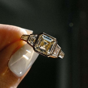 3.0 total carat weight Asscher cut lab created diamond engagement ring with a polished full bezel and delicate side stones. IGI certified for quality, this forever wedding ring offers sophisticated design and sustainable sparkle, making it an unforgettable symbol of commitment.