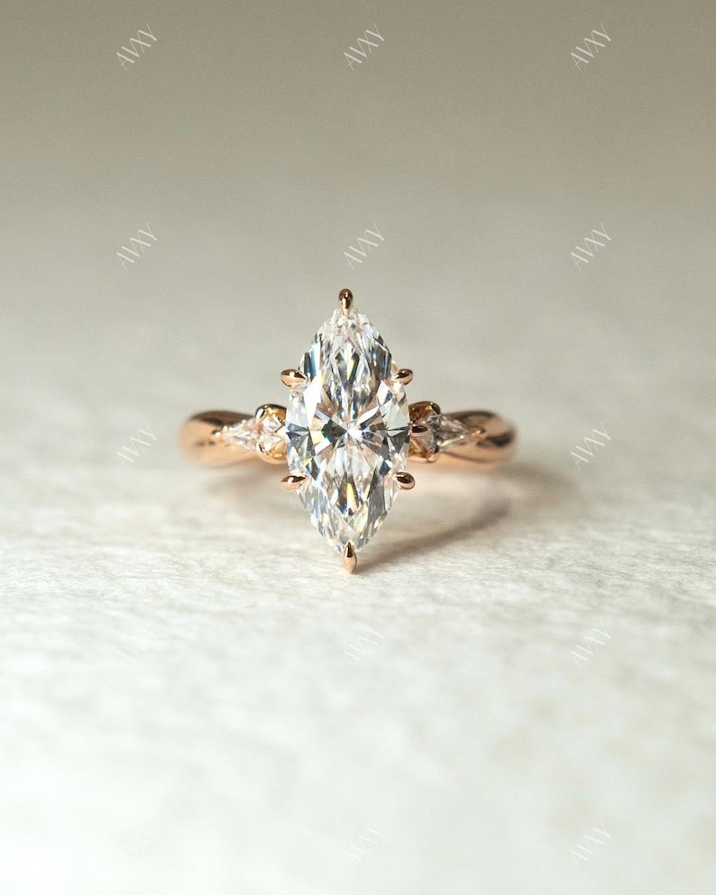 Elegant 2ct marquise lab grown diamond engagement ring featuring a three-stone setting and a refined pinched shank band. This wedding or anniversary ring for her blends timeless beauty with sustainable brilliance — a thoughtful gift for your girlfriend or a lasting bridal symbol.