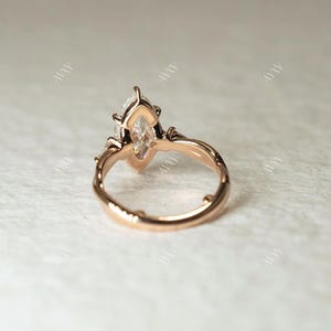 This 2ct marquise cut lab grown diamond three stone ring features a pinched shank for elegant symmetry and style. Whether used as a wedding ring, anniversary gift, or engagement ring for her, this dazzling piece symbolizes past, present, and future love in one timeless design.