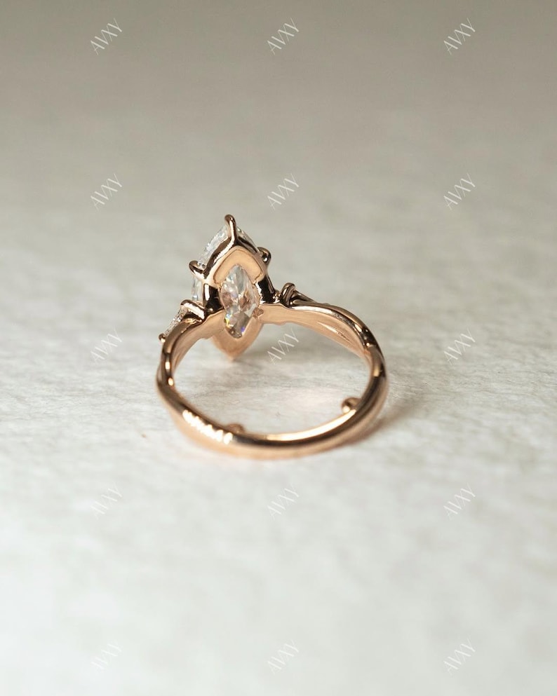 This 2ct marquise cut lab grown diamond three stone ring features a pinched shank for elegant symmetry and style. Whether used as a wedding ring, anniversary gift, or engagement ring for her, this dazzling piece symbolizes past, present, and future love in one timeless design.