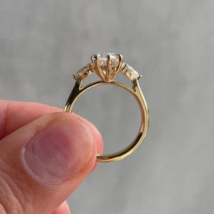 Top view of a pear 2ct lab created diamond cathedral ring with three stone arrangement symbolizing eternal love. This lab diamond engagement ring is ideal for wedding proposals, anniversaries, or luxury gifts. Loved by Etsy shoppers seeking eco-conscious alternatives to traditional diamond rings.