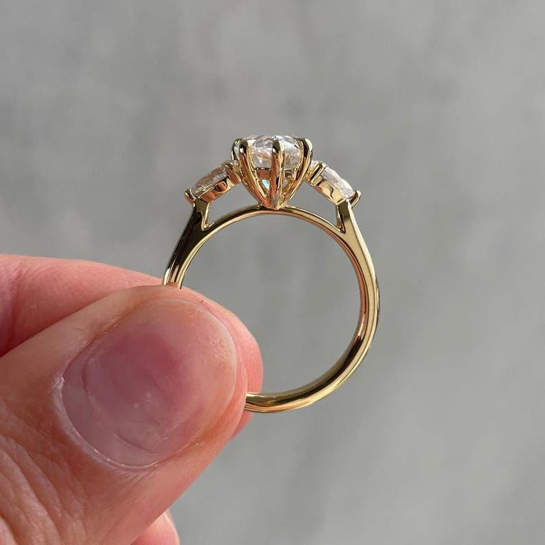 Top view of a pear 2ct lab created diamond cathedral ring with three stone arrangement symbolizing eternal love. This lab diamond engagement ring is ideal for wedding proposals, anniversaries, or luxury gifts. Loved by Etsy shoppers seeking eco-conscious alternatives to traditional diamond rings.