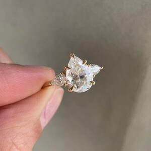 Stunning 2ct lab grown pear diamond ring featuring a cathedral shank and classic three stone design, making it the perfect engagement or wedding ring for her. This timeless style is an ethical and luxurious gift, widely searched on Etsy for its clean design and meaningful presentation.