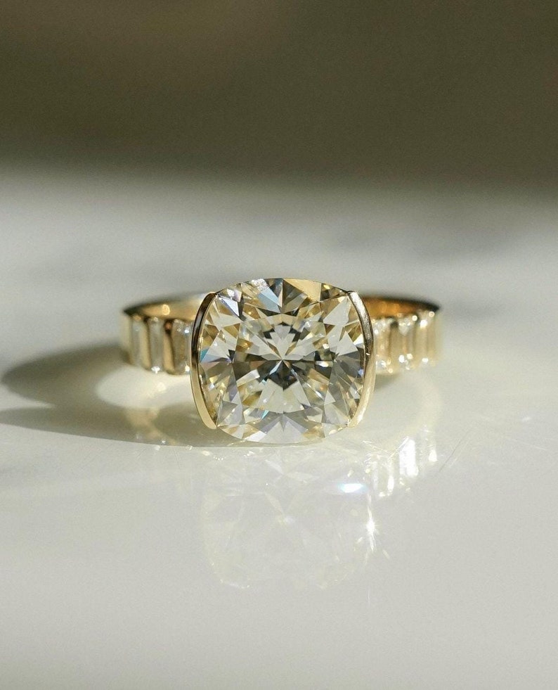 4ct cushion cut lab grown diamond ring with half bezel setting and budget pavé band. A stylish and affordable engagement or wedding ring for her.