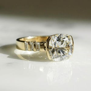 Cushion cut 4 carat lab created diamond ring with half bezel center and pavé band. A modern and elegant bridal or promise ring — ideal for everyday wear.