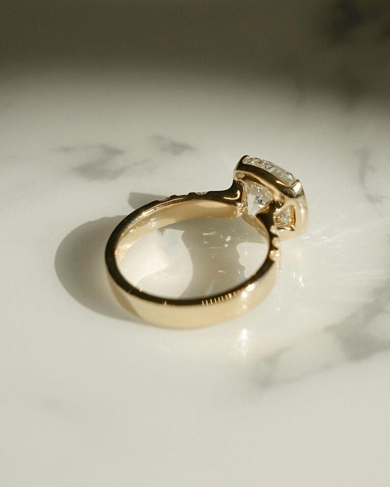 4ct cushion cut solitaire lab diamond ring with half bezel and pavé details. A beautiful engagement or anniversary gift for your special one.