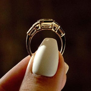 Asscher 3.0tcw lab grown diamond full bezel engagement ring accented with side stones. IGI certified for trusted origins, this wedding ring doubles as a timeless forever ring, celebrating a modern love story with clean lines and ethical craftsmanship.
