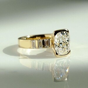 This 2ct lab-grown cushion diamond ring features a modern half bezel design and flowing flair shank band. A beautiful engagement or birthday gift ring for her, crafted with love and responsibility—ideal for anniversaries or as a heartfelt promise ring.