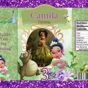 May include: A party favor bag featuring a princess theme with the text "Camila Turning 3". The design includes illustrations of a young girl in a green dress, a frog, and a cartoon alligator. The bag has a purple glitter border.
