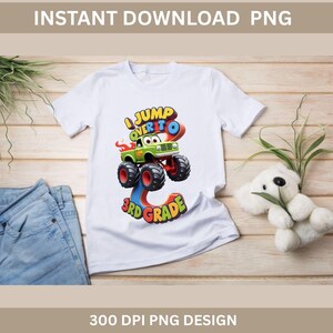 May include: White t-shirt with a colorful graphic of a monster truck jumping over the number 3, with the text "I Jump Over To 3rd Grade." The design is a PNG file.