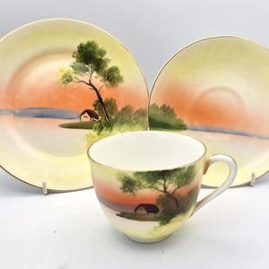 May include: A set of three ceramic mugs with a speckled, matte finish. The mugs are in shades of cream, light grey, and dark grey. Each mug has a simple, minimalist design and a rounded handle. The mugs are suitable for coffee, tea, or other beverages.