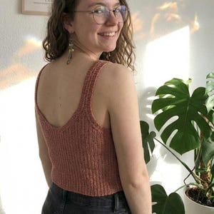 May include: A set of three ceramic mugs with a speckled, matte finish. The mugs are in shades of cream, light gray, and dark gray. Each mug has a simple, minimalist design and a rounded handle.