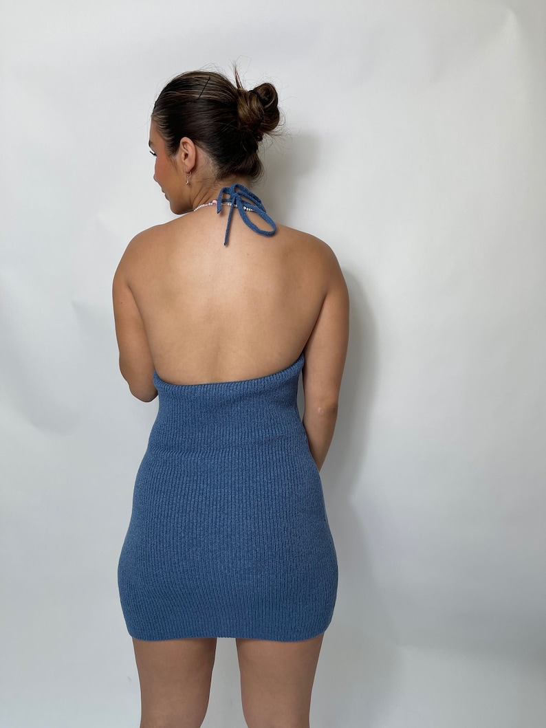 May include: A blue halter-style mini dress with a ribbed texture.