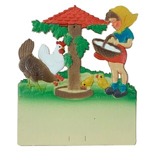 May include: A vintage, colorful, hand-painted, wooden, wall-mounted,  farm scene with a girl in a yellow bonnet and blue dress, a brown hen, a white hen, and three yellow chicks. The girl is holding a basket of eggs. The scene is set under a red roofed, wooden, birdhouse.