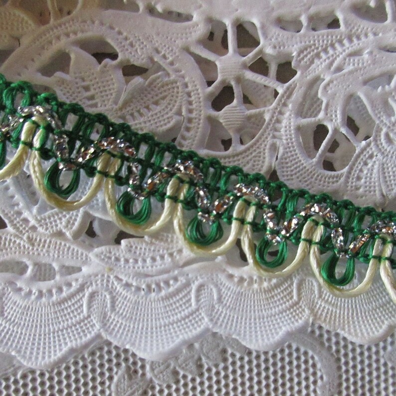 May include: Green and cream trim with silver thread, a decorative trim for sewing and crafting projects.