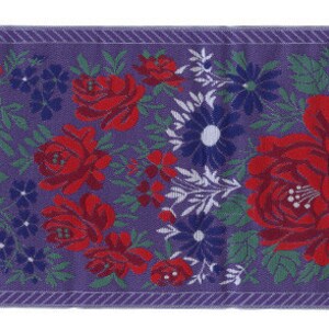 May include: A purple fabric ribbon with a repeating pattern of red roses, white flowers, and green leaves.