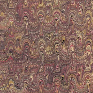May include: A close-up of a marbled paper with a swirling pattern of red, brown, and gold colors.