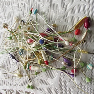 May include: A collection of colorful floral stems with various colored beads and tips. The stems are made of wire and are perfect for crafting and floral arrangements.