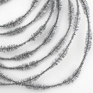 May include: Silver tinsel garland, a decorative trim with a metallic finish, perfect for adding sparkle to crafts and holiday decor.
