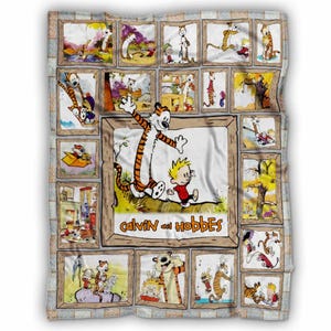 May include: A white blanket featuring a collage of Calvin and Hobbes comic strips. The central image shows Calvin and Hobbes with the text "Calvin and Hobbes". The blanket has a light gray and brown border.