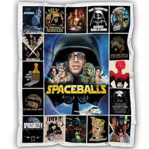 May include: A white fleece blanket featuring a collage of images and text from the movie "Spaceballs." The central image is a movie poster with characters and the title. Other squares include quotes and character illustrations.