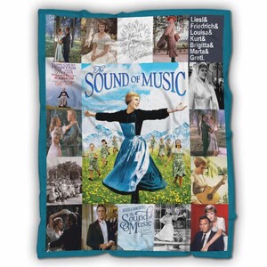 May include: A teal-bordered blanket featuring a collage of images from "The Sound of Music." The central image shows a woman with outstretched arms. Other images include movie stills and the film's title.