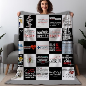 May include: A black and white throw blanket with quotes and phrases from the TV show Grey's Anatomy. The blanket features a grid pattern with various quotes and images, including hearts, stethoscopes, and the show's logo.