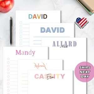 May include: Set of five personalized stationery notepads with different names and designs. The notepads are white with colorful text and designs. The names on the notepads are David, Mandy, Erin, Nick, and David. The notepads are all the same size and have a lined design.