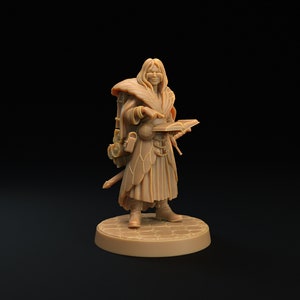 May include: A brown painted miniature figurine of a person wearing a long robe and holding a book. The person has long hair and is wearing a backpack with pouches. The figurine is standing on a circular base.