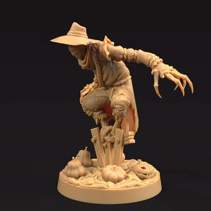 May include: A tan-colored figurine of a scarecrow with a wide-brimmed hat, tattered clothing, and long, claw-like fingers. The scarecrow is perched on a wooden fence with pumpkins at its base, creating a Halloween theme.