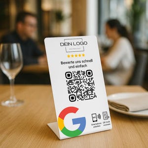 Könnte beinhalten: Ein weißer Tischaufsteller mit einem QR-Code und dem Google-Logo. Der Text auf dem Aufsteller lautet "DEIN LOGO" und "Bewerte uns schnell und einfach." Der Aufsteller zeigt auch eine Grafik für NFC- und QR-Code-Scannen.