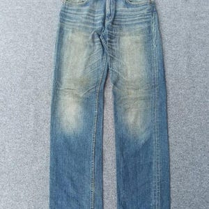 Wyblakłe jeansy Levi’s Japan 502 Distressed. Rozmiar 30.