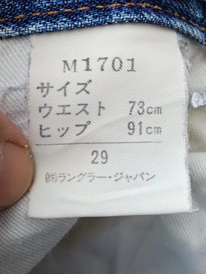 Pu&ograve; includere: Una tazza di ceramica bianca con manico nero e la scritta "But First, Coffee" in nero, in grassetto. La tazza &egrave; appoggiata su una superficie di legno. La tazza &egrave; alta 10 cm.