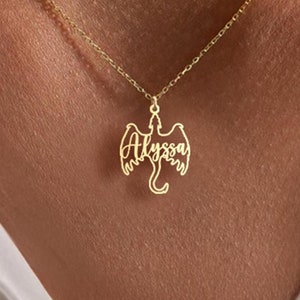 May include: A gold necklace with a dragon pendant featuring the name "Alyssa" in a cursive font.