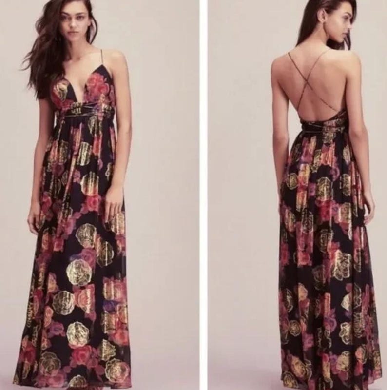 May include: A long, black floral print dress with a plunging neckline and spaghetti straps. The dress features a pattern of red and gold flowers and gold metallic accents. The back of the dress has a criss-cross strap design.