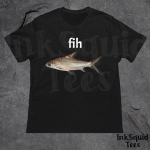 May include: Black t-shirt featuring a fish graphic with the word "fih" above it. The fish is a detailed illustration with scales and fins. The text "InkSquid Tees" is at the bottom.