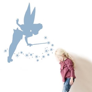 May include: A blue silhouette of Tinkerbell with wings and a wand, sprinkling fairy dust. A young girl with blonde hair is looking at the fairy dust.