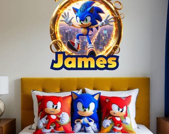 May include: A bedroom scene featuring a wall decal of Sonic the Hedgehog above a bed with three character pillows. The decal includes the name "James" in yellow. The pillows depict Sonic and Knuckles.