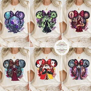May include: Cream-colored t-shirts featuring Disney villain designs within Mickey Mouse ear silhouettes. Each design includes a bow and the word "NAME". The villains include Ursula, Maleficent, and the Evil Queen.