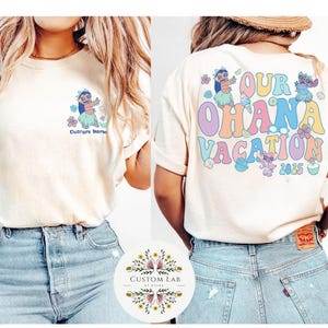 May include: Cream-colored t-shirts with a colorful design. One shirt features a cartoon character and the text "Custom Name". The other shirt has the text "Our Ohana Vacation 2025" with cartoon characters.