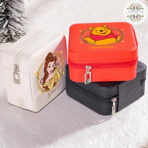 May include: Three square jewelry boxes in white, red, and black. The white box features a princess graphic and the name "Jennifer". The red box has a Winnie the Pooh graphic and the name "Jennifer". The black box is plain.