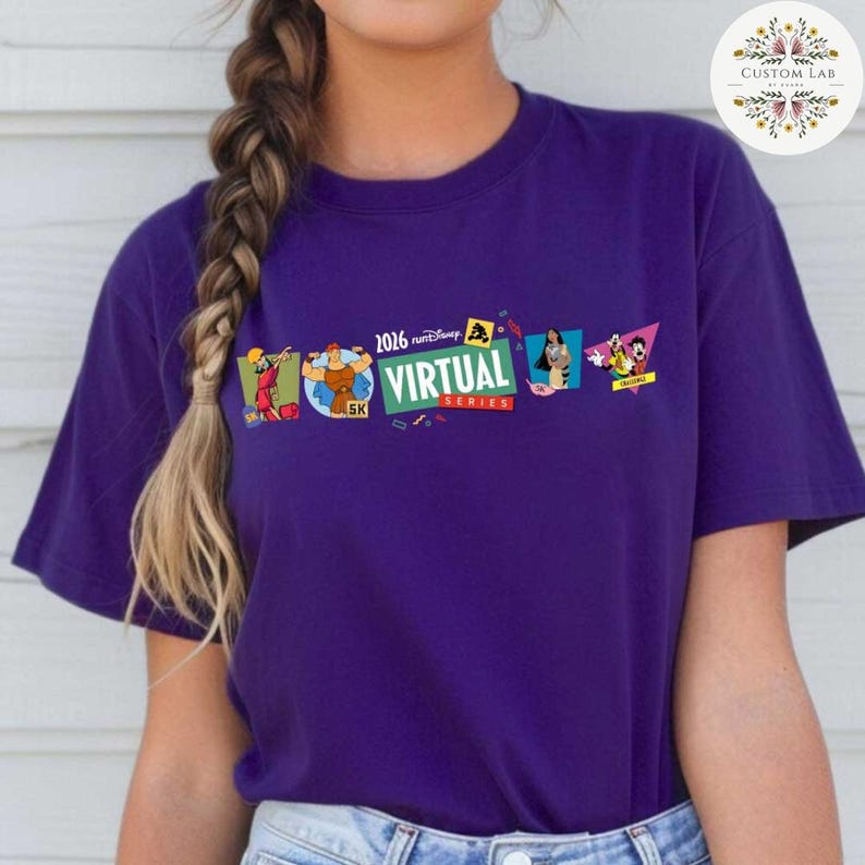 May include: A purple t-shirt featuring the text "2026 Disney Virtual Series" with cartoon character graphics. The shirt has a crew neck and short sleeves. The design includes images of cartoon characters.