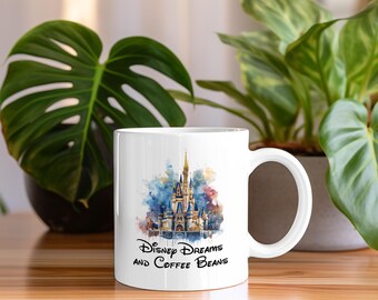 May include: White ceramic mug with a watercolor illustration of Cinderella's castle and the text "Disney Dreams and Coffee Beans".