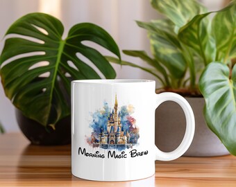 May include: White ceramic mug with a watercolor illustration of Cinderella's Castle and the text "Morning Magic Brew".