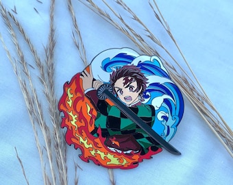May include: A colorful enamel pin featuring a character from the anime Demon Slayer. The character is holding a sword and is surrounded by flames and water. The pin is a great way to show your love for the anime.