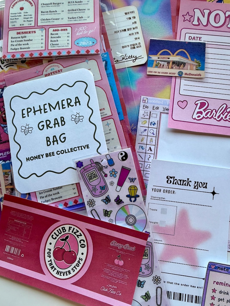 May include: A collection of stationery ephemera including a menu card, a Barbie notepad, a thank you card with a pink star, a sticker sheet with Y2K icons, and a Club Fizz Co cherry soda label. The items feature various fonts, graphics, and colors.