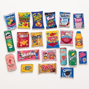 May include: A collection of twenty-one individual stickers featuring various snack and beverage brands including Capri Sun, Gushers, Takis, Trolli, Welch's, Pop-Tarts, Pringles, Cheez-It, M&Ms, Swedish Fish, Uncrustables, SunnyD, Olipop, Skittles, ramen, Alani, Sprite, Pop Rocks, Juicy Fruit, Twix, and Oreo.
