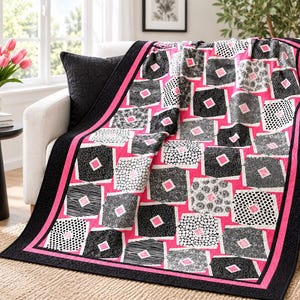 May include: A quilt featuring a vibrant hot pink background with a repeating pattern of black and white squares. Each square contains a smaller pink diamond in the centre. The quilt is finished with a wide black border and a thin pink trim.