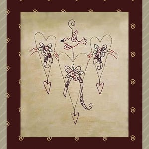 May include: A framed artwork featuring a cream-colored background with a stitched design. The design includes three connected hearts, each with a flower and a dangling heart. A bird is perched above the central heart. The frame is dark brown with a decorative border.